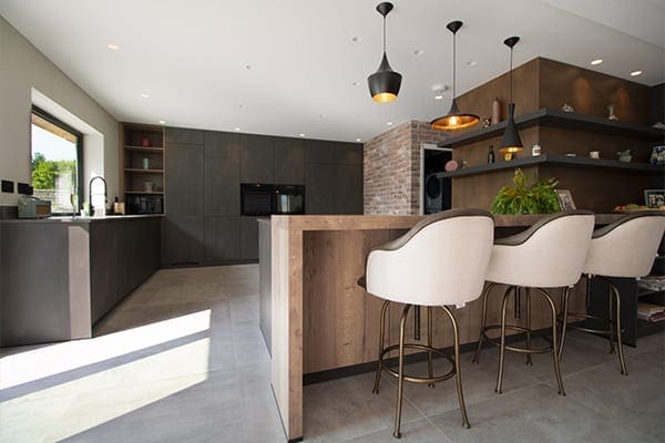 Schüller Targa kitchen with dark steel effect doors and large peninsula seating, a Cardiff Artisan Kitchen Studio installation