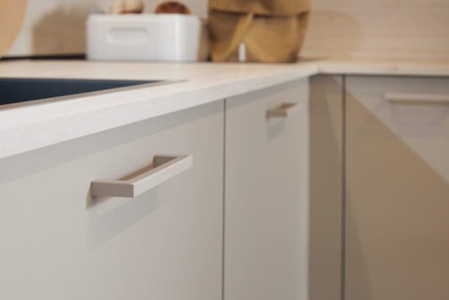 Detailed image focusing on the unique OceanIX handles made from recycled ocean plastics, featured in the Matera kitchen, emphasizing the eco-friendly design.